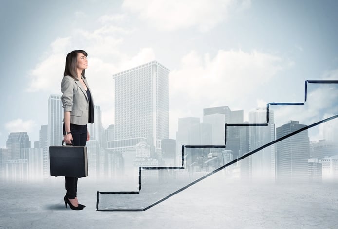 Business person in front of a staircase, city on the background.jpeg