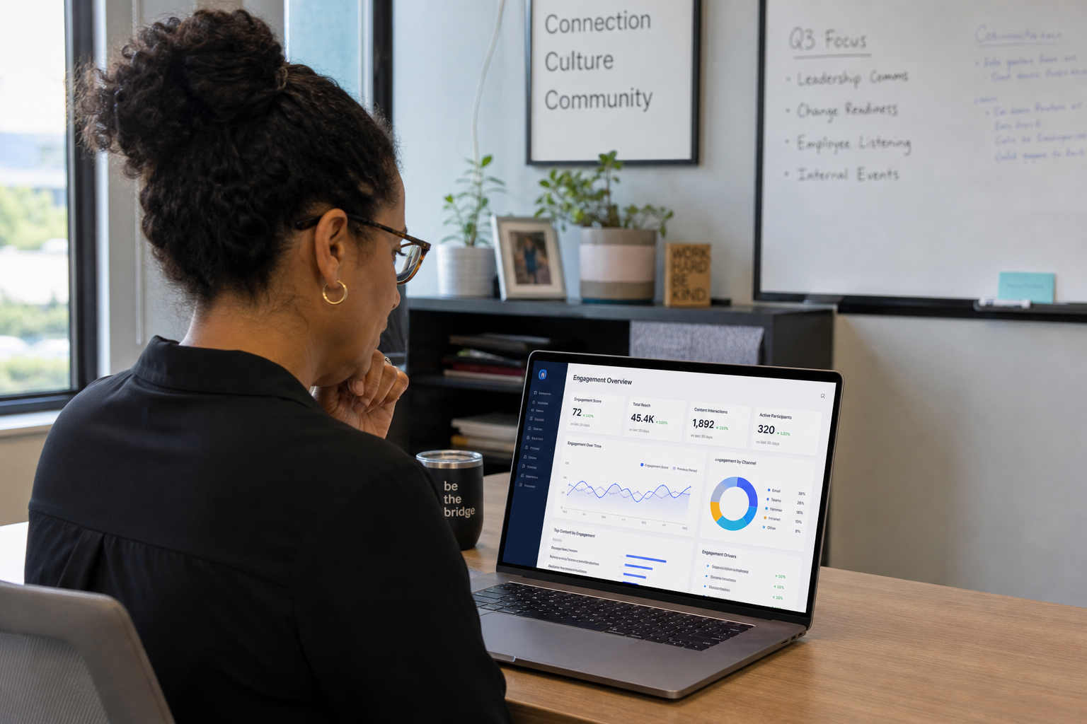 Internal communications manager reviewing employee engagement analytics on a laptop dashboard