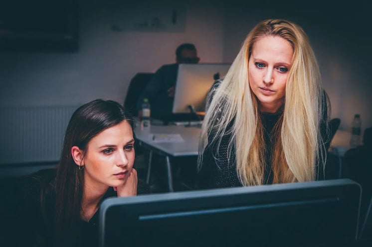 women-presenters-in-front-of-computer-screen