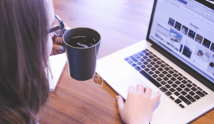 Woman on laptop with cup of tea