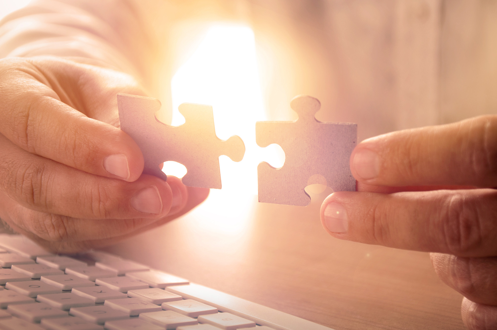 Person putting together two puzzle pieces