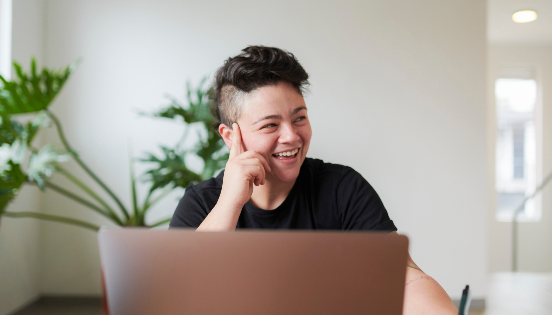 person sitting at table with laptop