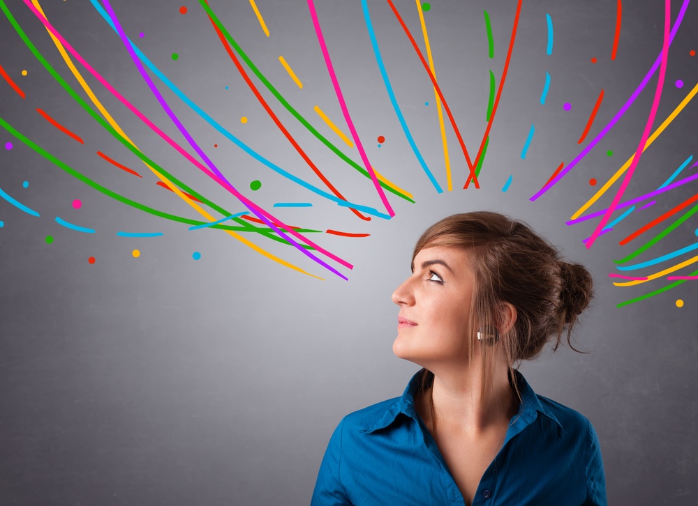 Woman looking up at colourful squiggly lines