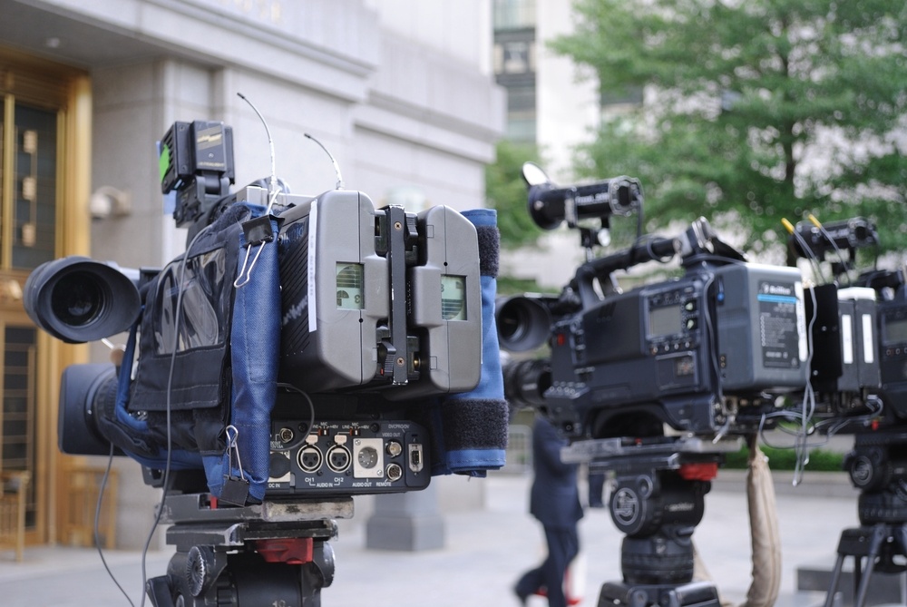 video cameras poised outside of a courthouse.jpeg