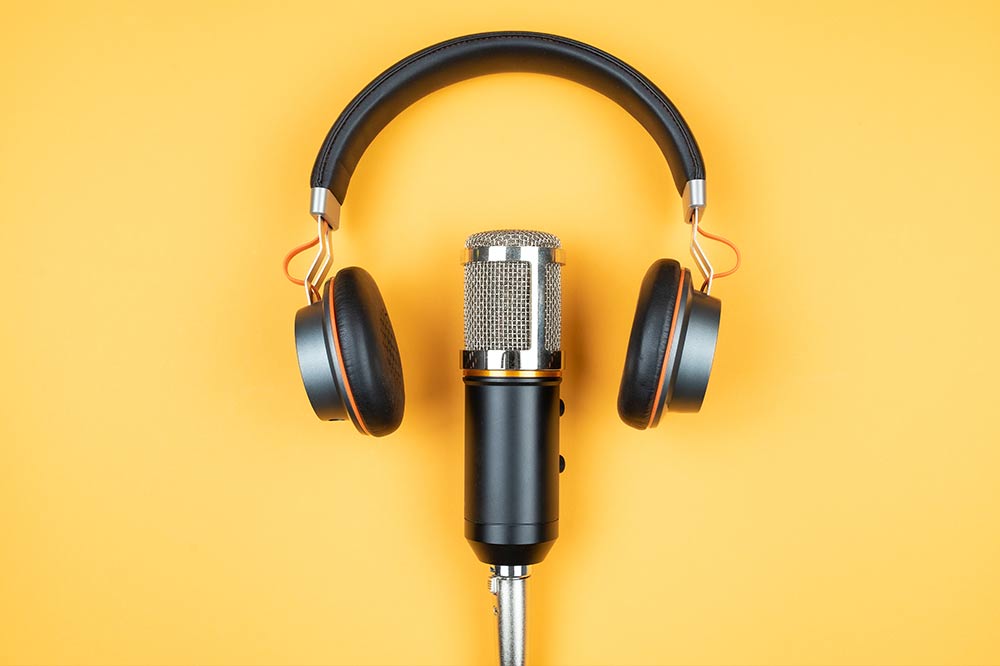 Headphones and mic on yellow background