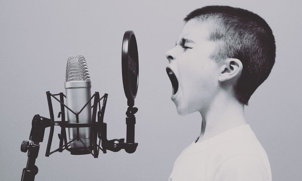 boy-yelling-into-a-microphone